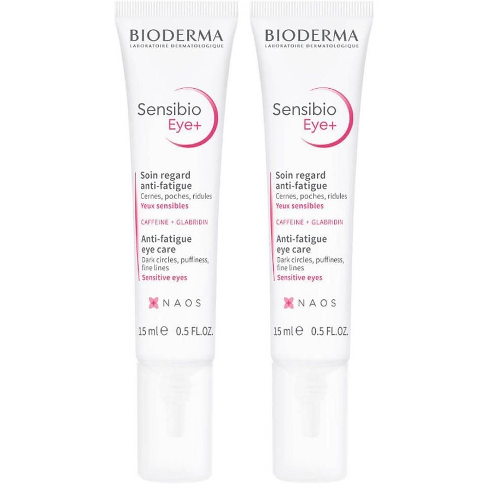 Twee tubes Bioderma Sensibio Eye+ Anti-Fatigue oogverzorging. Witte tubes met roze en zwarte tekst. 15 ml.