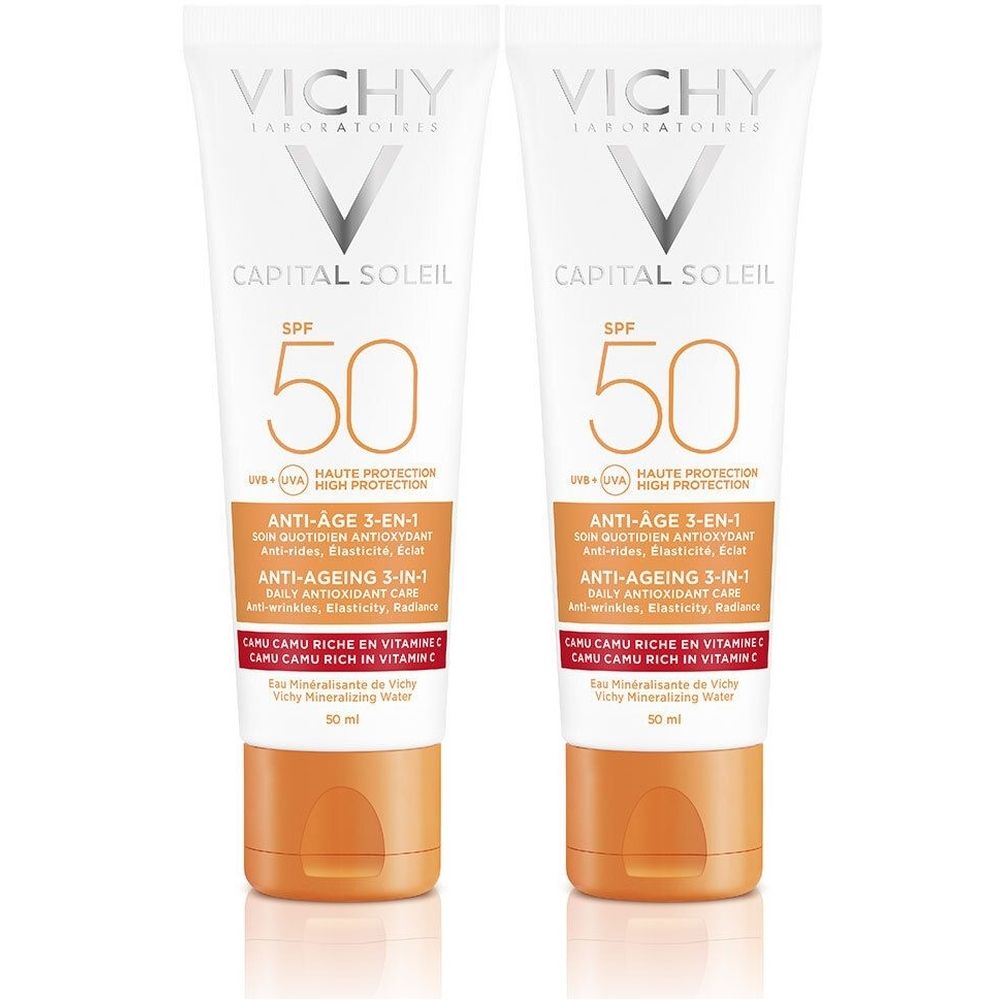 Twee tubes zonnebrandcrème. Wit, met oranje dop. Opschrift: VICHY, CAPITAL SOLEIL, SPF 50, Anti-Age 3-in-1.