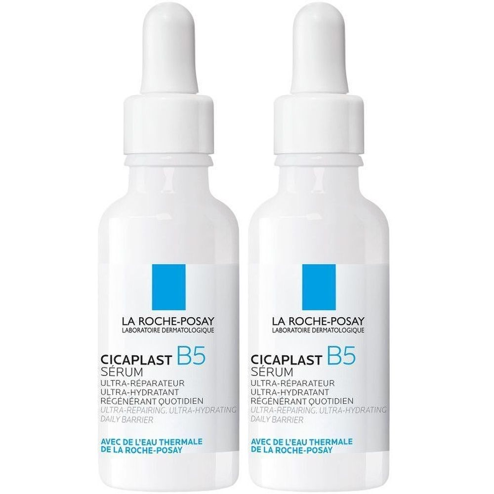 Twee witte flessen met pipet. Op elke fles staat "CICAPLAST B5 SERUM" en "LA ROCHE-POSAY".