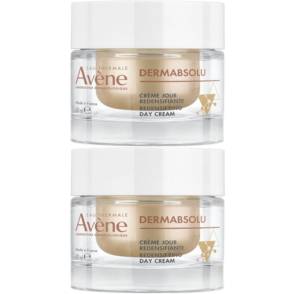 Twee potjes Avène Dermabsolu crème. Witte deksel, goudkleurig potje. Opschrift: Dermabsolu, Crème jour redensifiante.