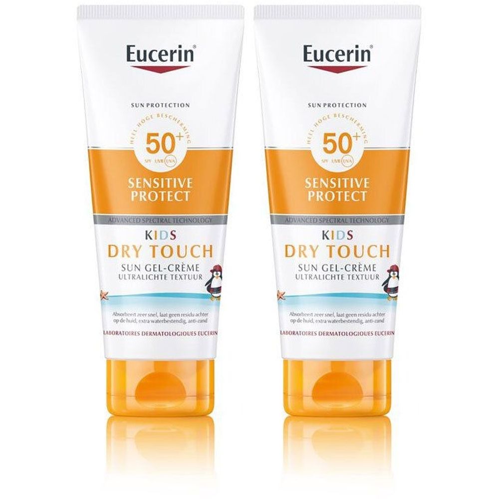 Twee tubes zonnebrandcrème. Wit-oranje verpakking met tekst en pinguïn illustratie. Merk Eucerin.