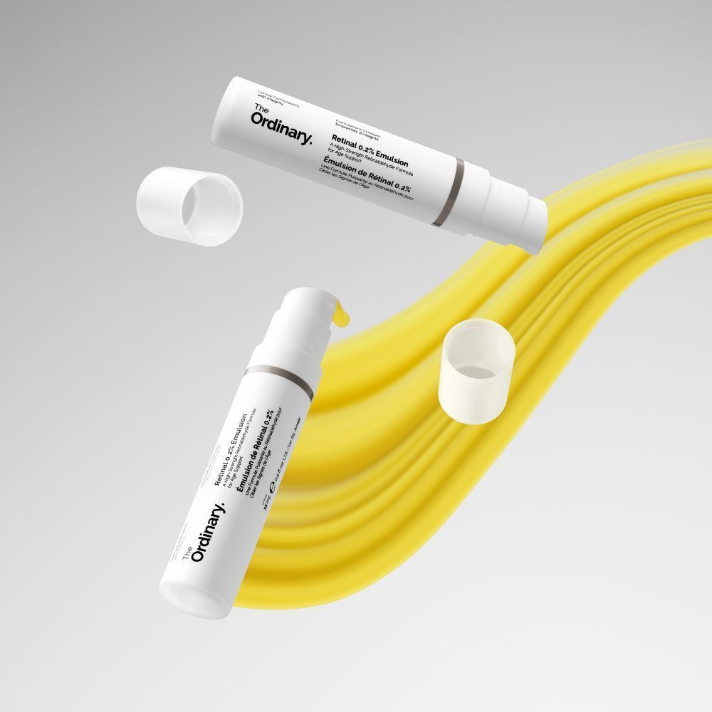 Twee witte flessen met pomp en gele achtergrond. Opschrift: Retinal 0.2% Emulsion. Merk: The Ordinary.
