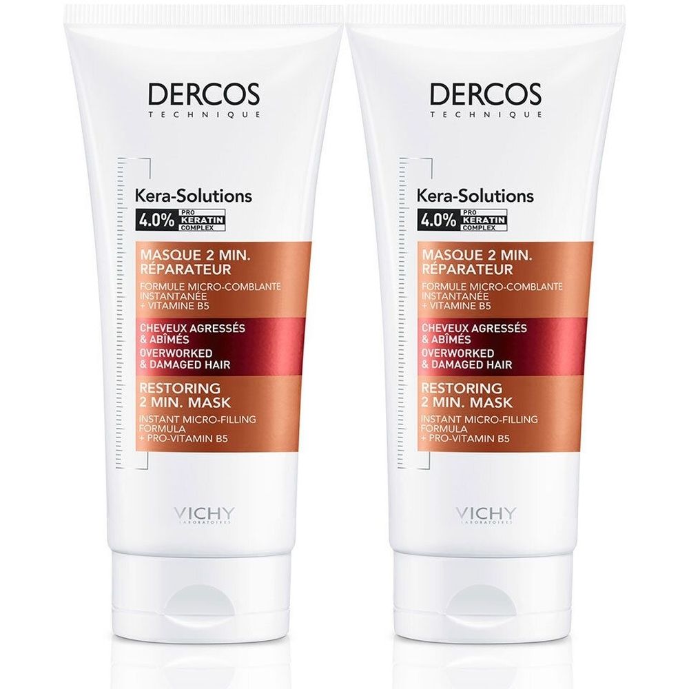 Twee tubes Dercos Kera-Solutions haarmasker. Wit, met bruine en rode accenten. Tekst: Kera-Solutions, 4.0% Keratine.