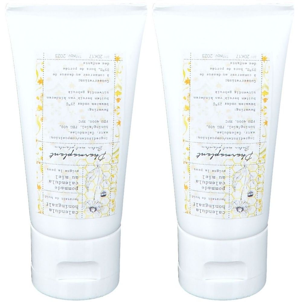 Twee witte tubes met etiketten. Opschrift: Calendula honingzalf. Merk: Pharmaplant. Gele decoratieve elementen.