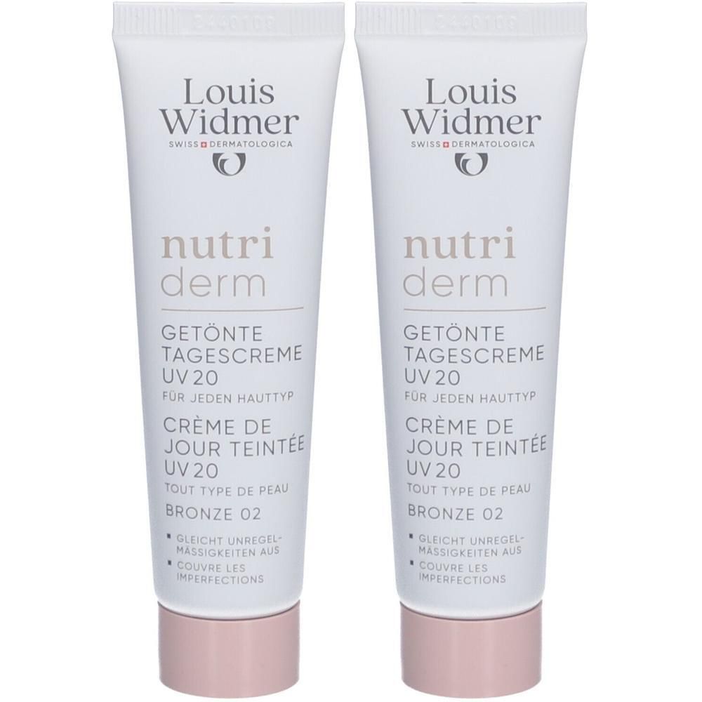 Twee tubes Louis Widmer Nutriderm Getönte Dagcrème UV20 Bronze 02. Witte tubes met tekst en logo. Roze dop.