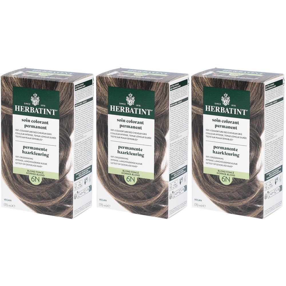Drie dozen Herbatint Soin Colorant Permanent 6N Blond Foncé. Groen-bruine verpakking met productinfo en haar afbeelding.