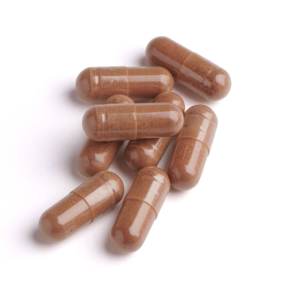 Zeven bruine capsules op witte achtergrond. Capsulevorm, transparante omhulsel.