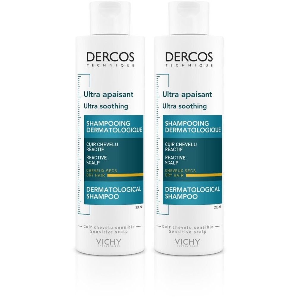 Twee witte shampoo flessen met blauwe en witte etiketten. Opschrift: Dercos, Ultra apaisant, Shampooing dermatologique.