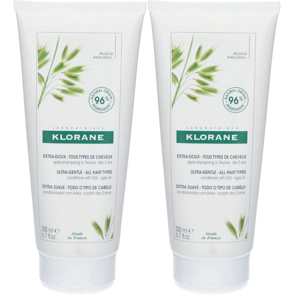 Twee witte tubes. Opschrift: Klorane, Extra-Doux, 96% natuurlijke ingrediënten. Illustratie van haveraren.