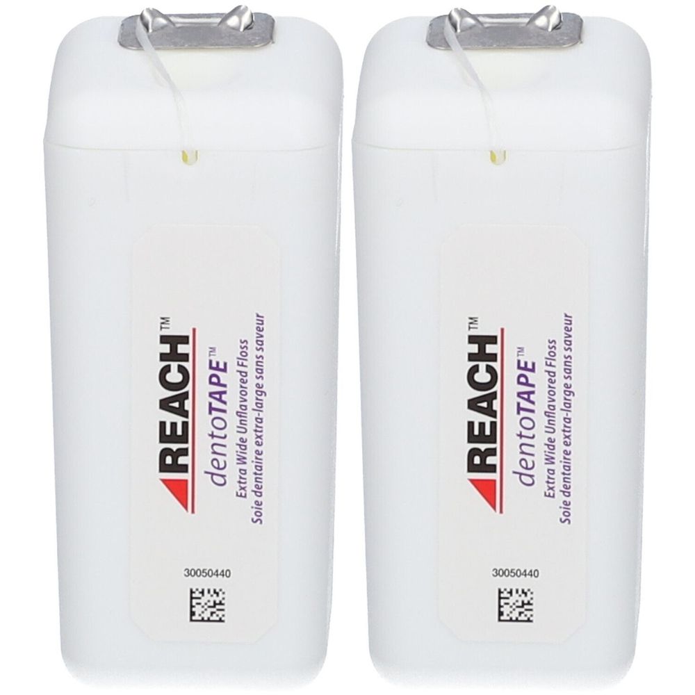 Deux boîtes blanches de fil dentaire. Inscription: REACH dentoTAPE, Extra Wide Unflavored Floss. Fermeture métallique.