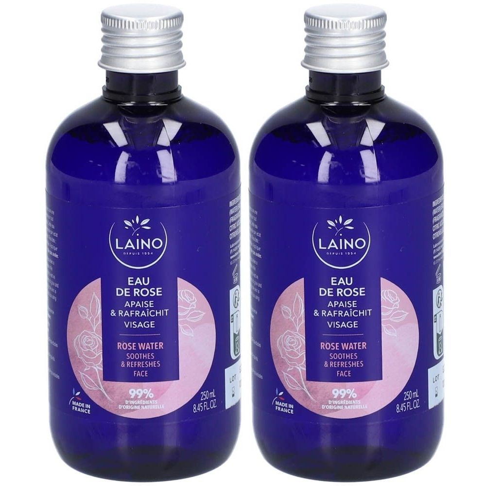 Twee blauwe flessen met zilveren doppen. Labels: "LAINO Eau de Rose", "Apaise & Rafraichit Visage". Bevat 99% ingrediënten van natuurlijke oorsprong.