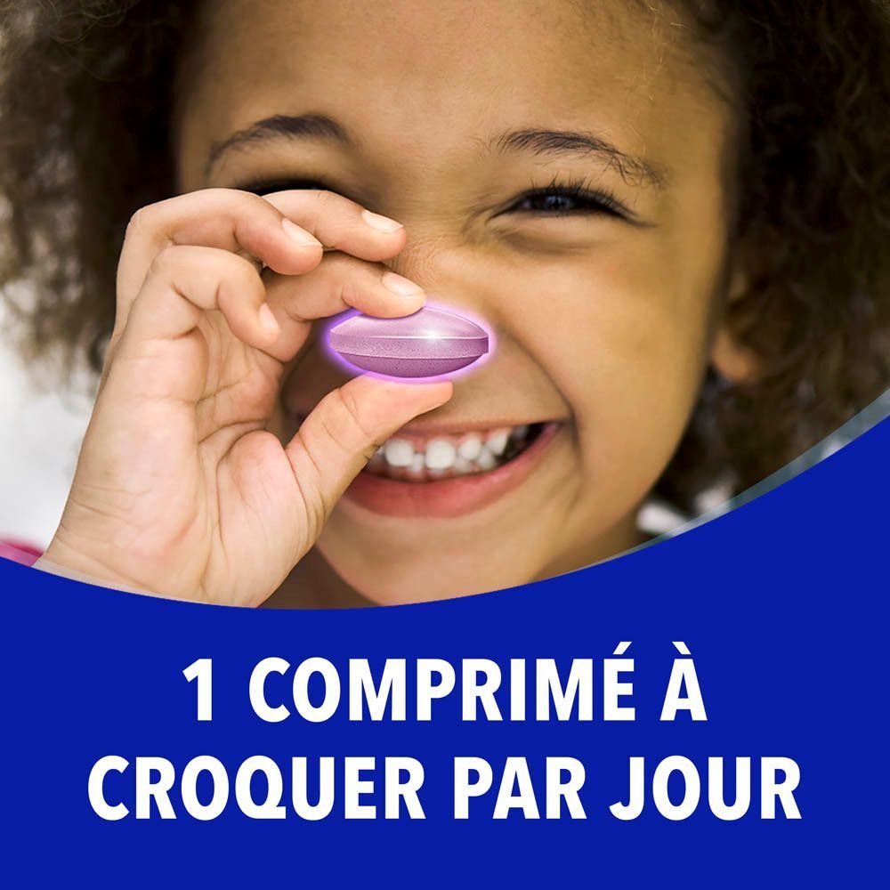 Comprimé rose avec visage et langue. Goût framboise. Framboises en arrière-plan. Fond bleu.