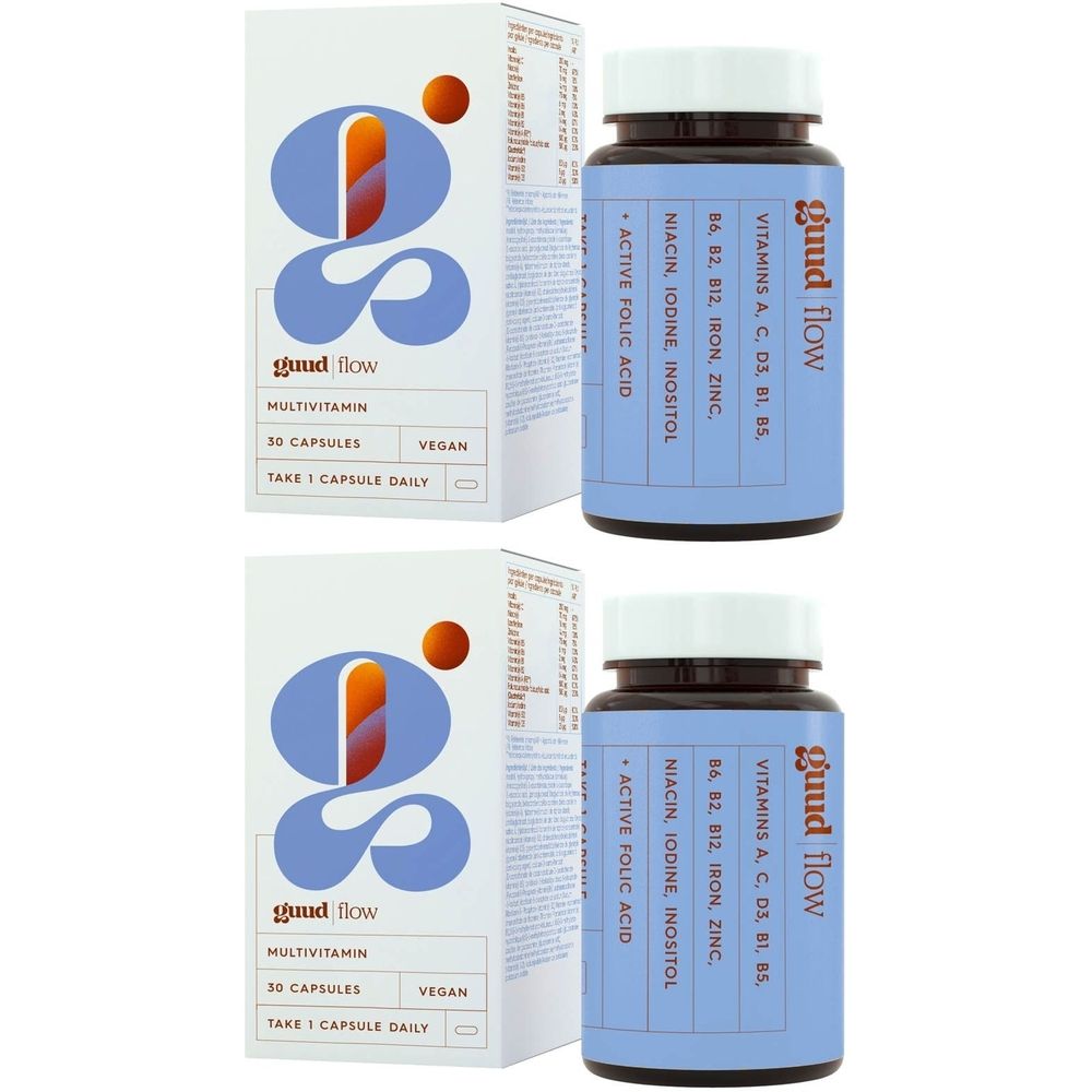 Deux flacons et deux boîtes avec le nom du produit « guud flow ». Les ingrédients sont indiqués sur les flacons. « Multivitamine » est écrit sur les boîtes.