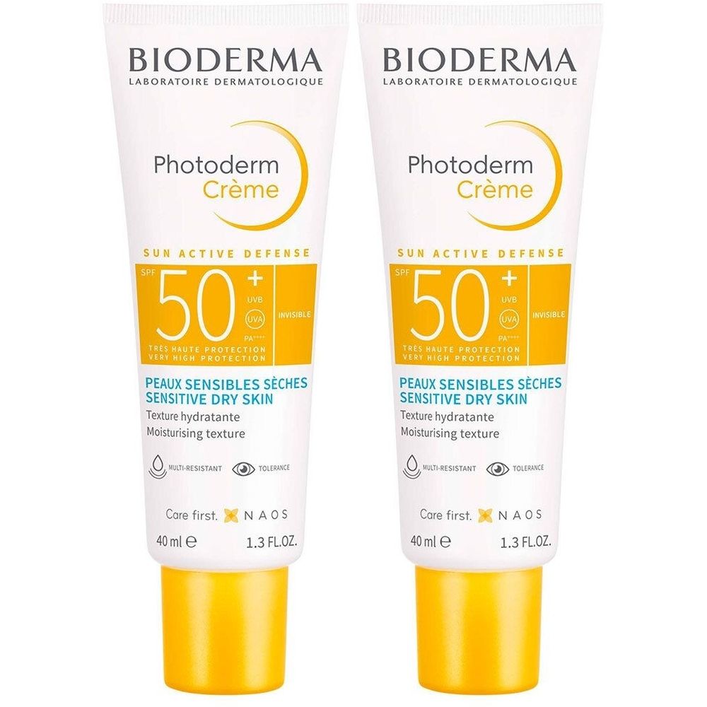 Deux tubes de Bioderma Photoderm Crème. Blanc, accents jaunes. Texte SPF 50+, Peaux Sensibles Sèches, 40 ml.