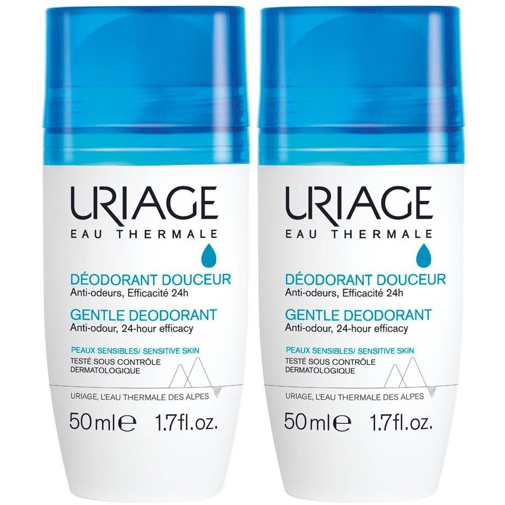 Deux déodorants roll-on blancs avec bouchons bleus. Texte: Uriage, Eau Thermale, Déodorant Douceur, Gentle Deodorant.