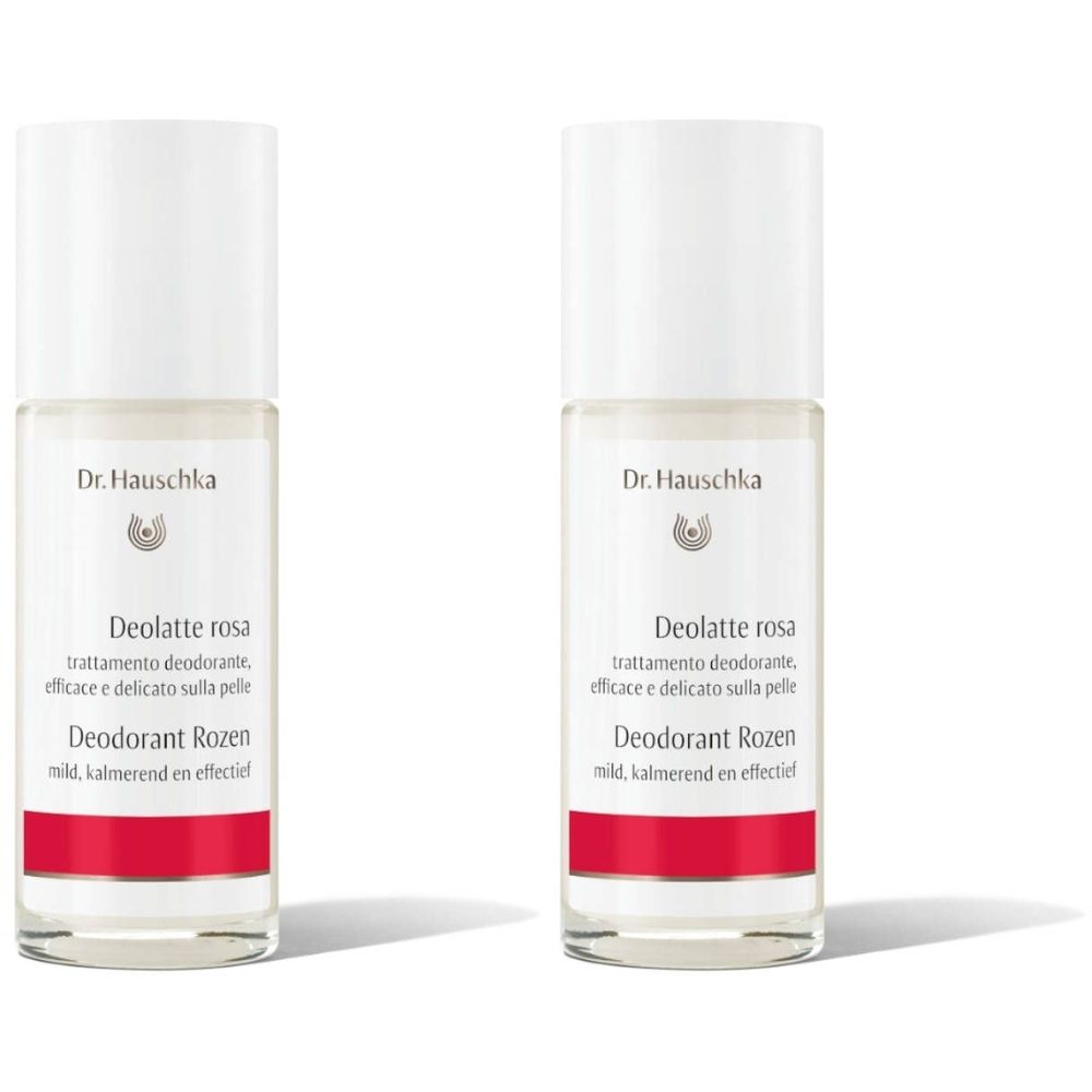 Twee Dr. Hauschka deodorant roll-ons. Witte flessen met witte dop en rode streep. Tekst: Deolatte rosa, Deodorant Rozen.