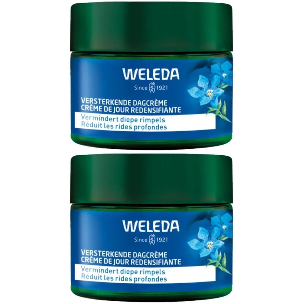 Deux pots de crème bleue. Inscription: WELEDA, VERSTERKENDE DAGCRÈME, Crème de jour redensifiante. Réduit les rides profondes.