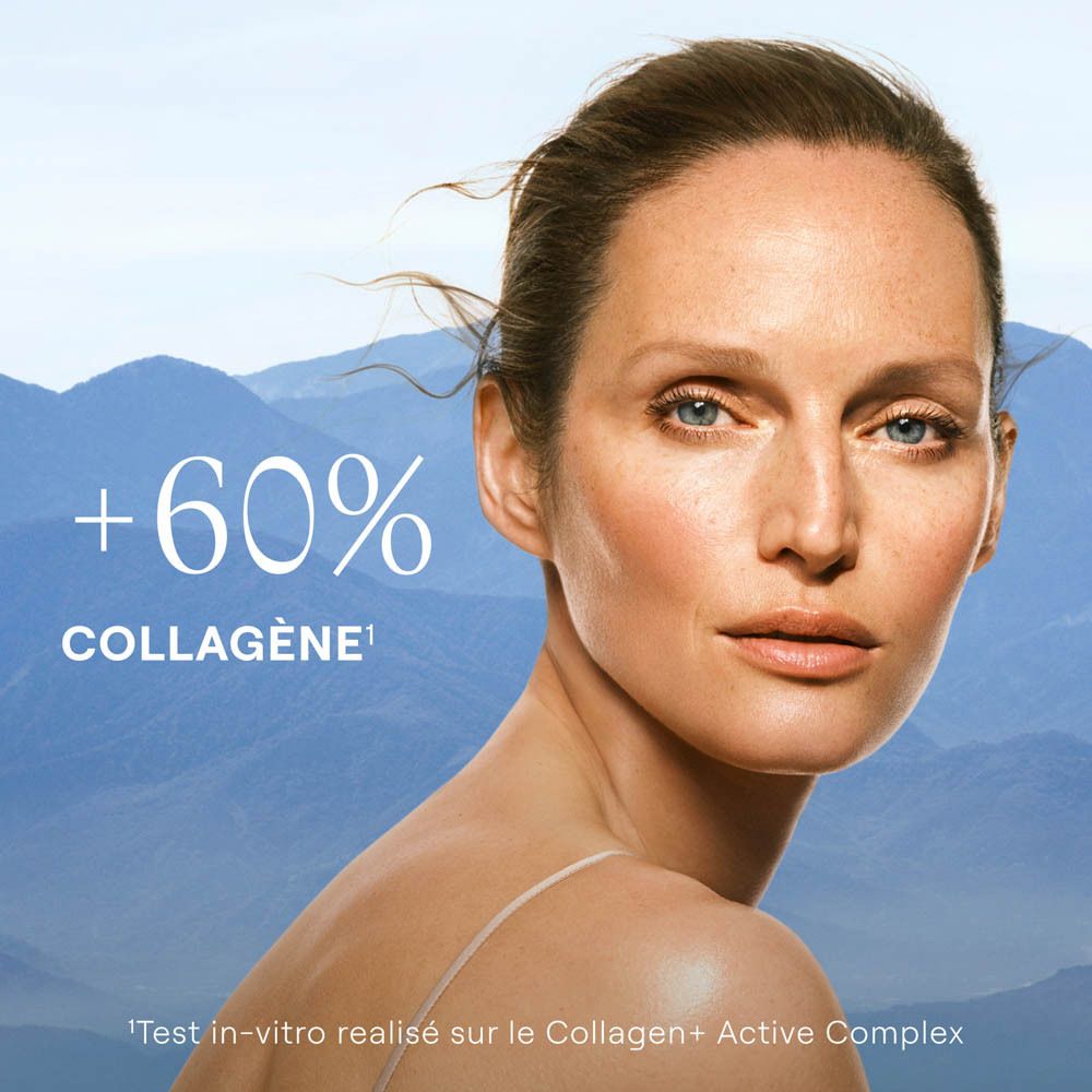 Femme à la peau radieuse devant un paysage de montagne, +60% collagène.