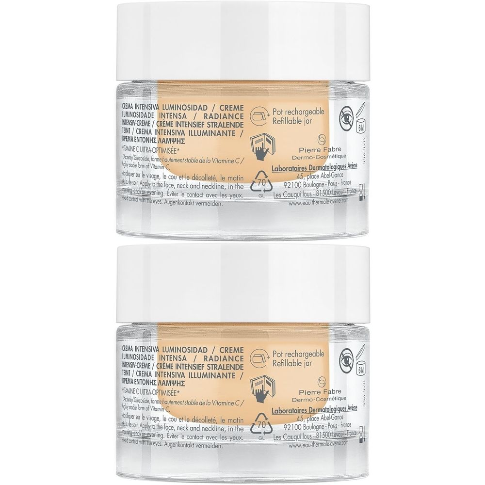 Deux pots de crème avec couvercles blancs. Inscriptions: Creme Intensiva, Radiance. Inscriptions et logos. Pot rechargeable.