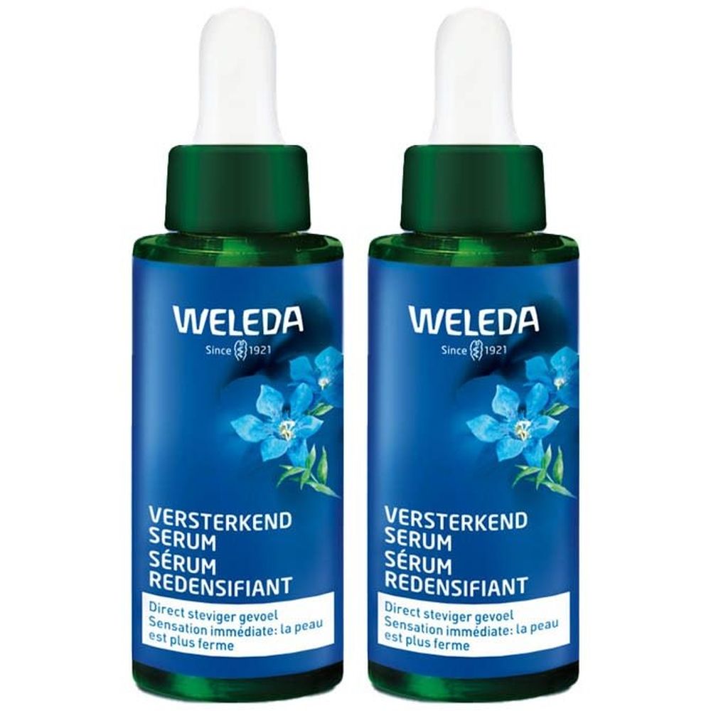 Deux flacons de sérum. Flacons bleus avec bouchon vert et pipette. Inscription: WELEDA, VERSTERKEND SERUM, SÉRUM REDENSIFIANT.