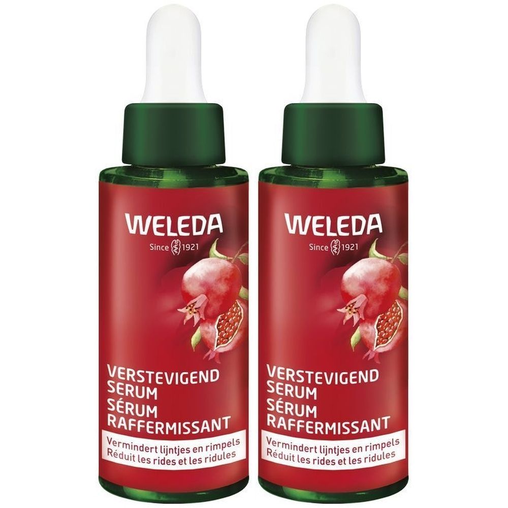 Twee serumflessen met groene doppen en rode etiketten. Opschrift: WELEDA, VERSTEVIGEND SERUM, SÉRUM RAFFERMISSANT.