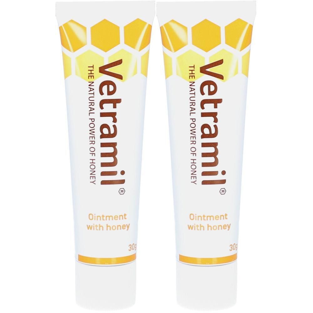 Twee tubes Vetramil® Onguent au miel. Witte tubes met geel honingraatontwerp en tekst.