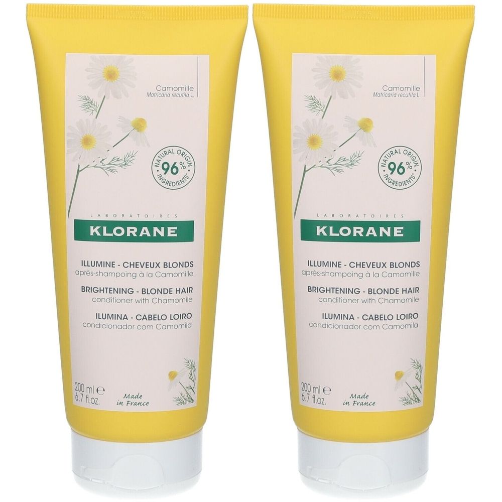 Deux tubes jaunes de revitalisant Klorane. Inscription : Illumine Cheveux Blonds, 96% ingrédients naturels. Illustration de fleurs de camomille.