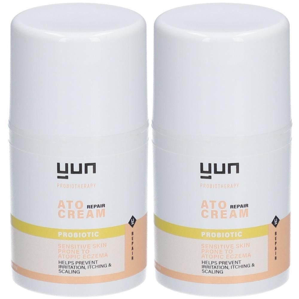 Twee witte crèmetubes met gele streep en tekst. ATO REPAIR CREAM, PROBIOTIC. Helpt irritatie, jeuk en schilfering te voorkomen.