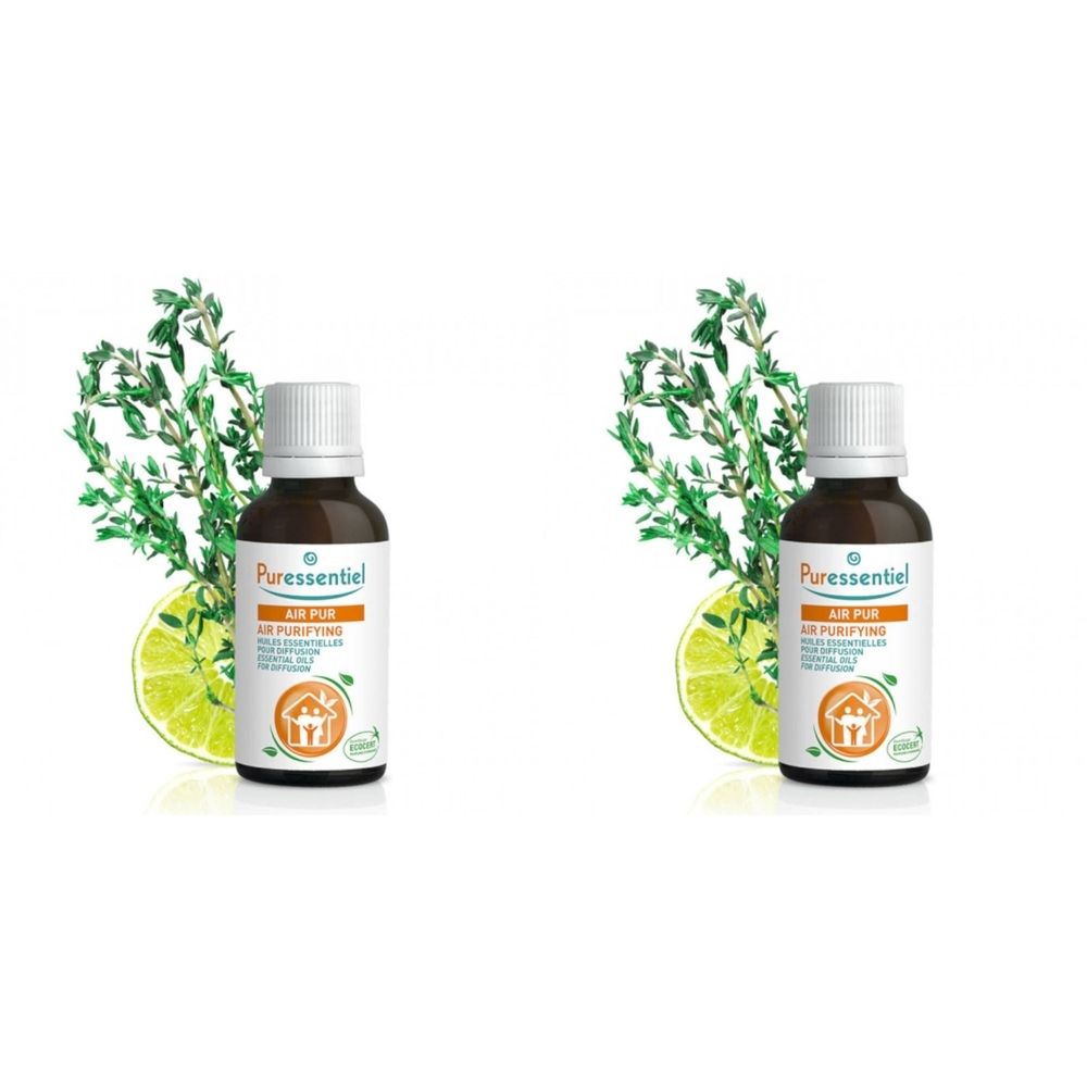 Twee bruine glazen flessen met witte dop. Opschrift: Puressentiel, Air Pur. Versierd met kruiden en limoenschijfjes.