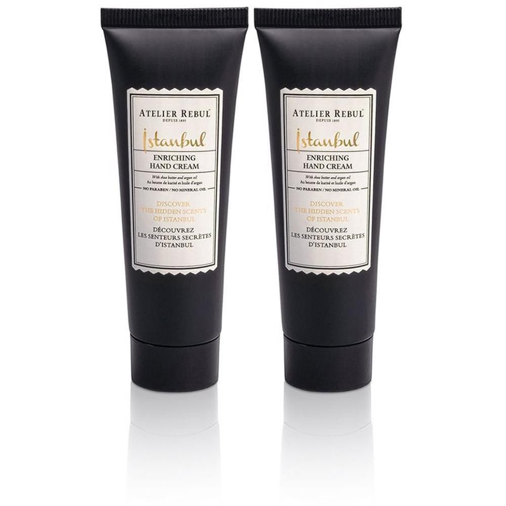 Twee zwarte tubes handcrème met wit etiket. Opschrift: ATELIER REBUL Istanbul Enriching Hand Cream.