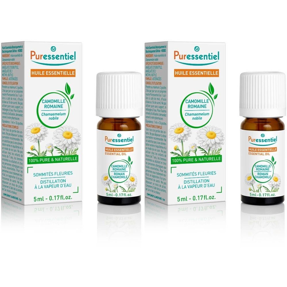 Trois flacons et emballages. Sur les emballages, on lit "Puressentiel Huile Essentielle Camomille Romaine". Les flacons sont bruns avec des bouchons blancs.
