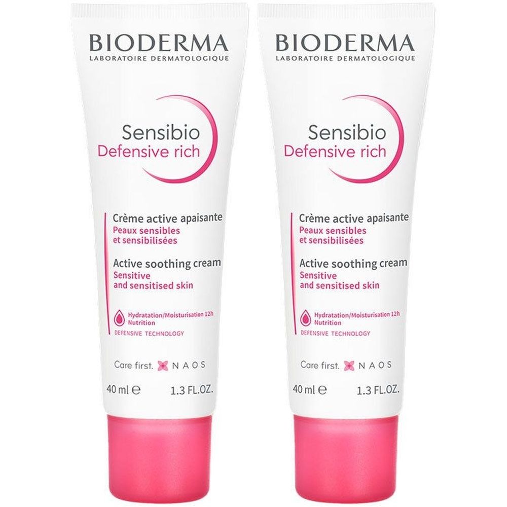 Deux tubes de Bioderma Sensibio Defensive Rich. Tubes blancs avec accents roses. Texte: Crème active apaisante, Active soothing cream.