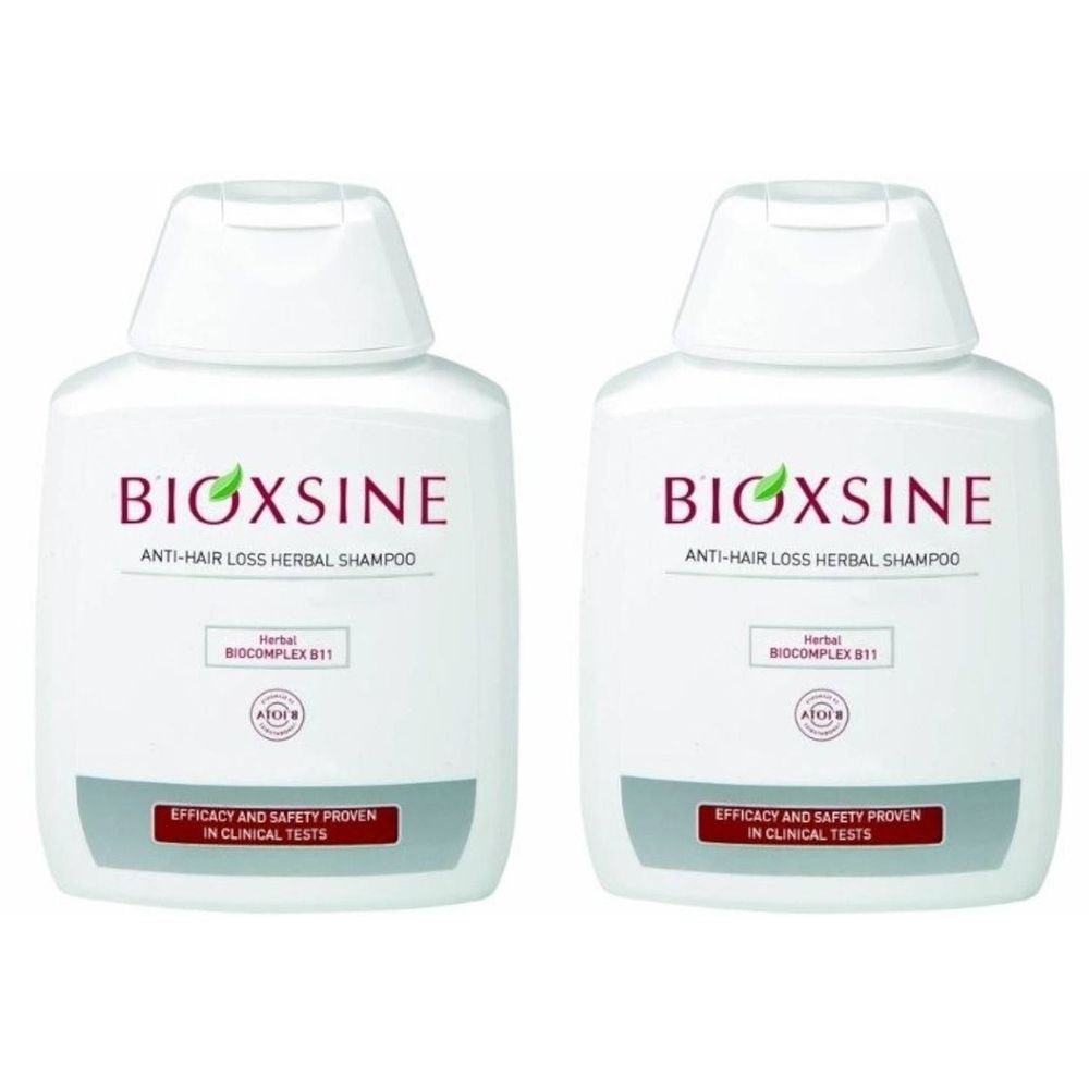 Twee witte flessen met de tekst BIOXSINE. Opschrift: Anti-haaruitval kruidenshampoo. Logo en tekst: Efficacy and Safety Proven in Clinical Tests.