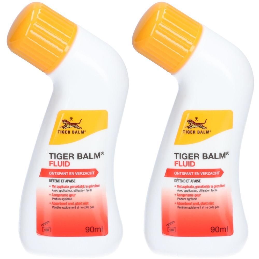 Twee flessen Tiger Balm® Fluid. Witte flessen met gele doppen. Rode en gele opdruk. 90ml.