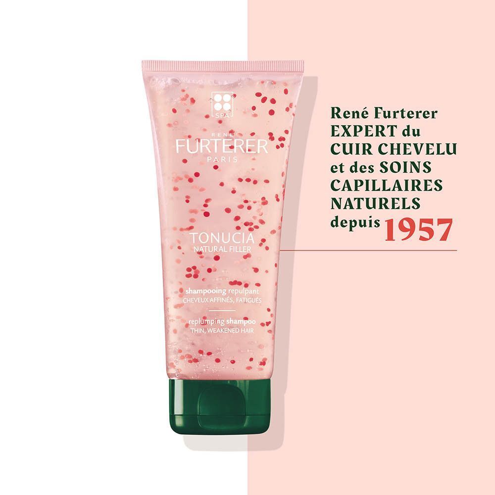 Tube transparent avec gel rose et particules rouges, bouchon vert. "René Furterer" et "TONUCIA" sont visibles.