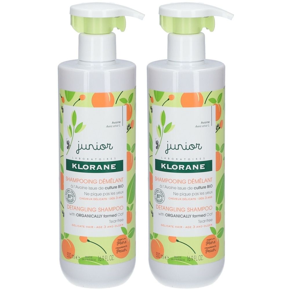 Twee witte flessen met groen en oranje etiket. Opschrift: Klorane Junior Shampooing Démêlant. Met doseerpomp.