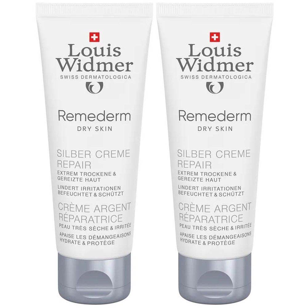 Deux tubes de Crème Argent Réparatrice Louis Widmer. Tubes blancs avec bouchons argentés et inscriptions du produit.