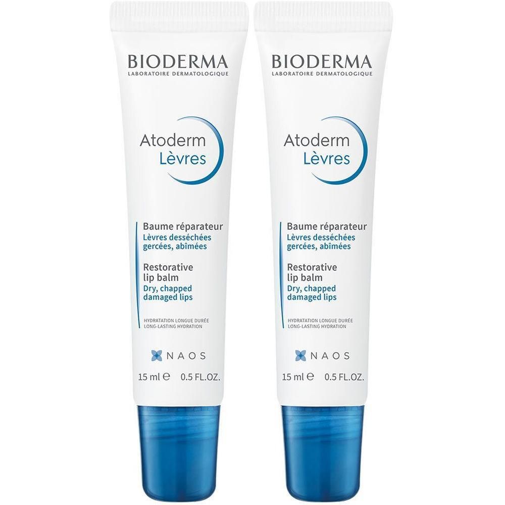 Twee tubes lippenbalsem, wit met blauwe accenten. Opschrift: Bioderma, Atoderm Lèvres, Baume réparateur, 15 ml.