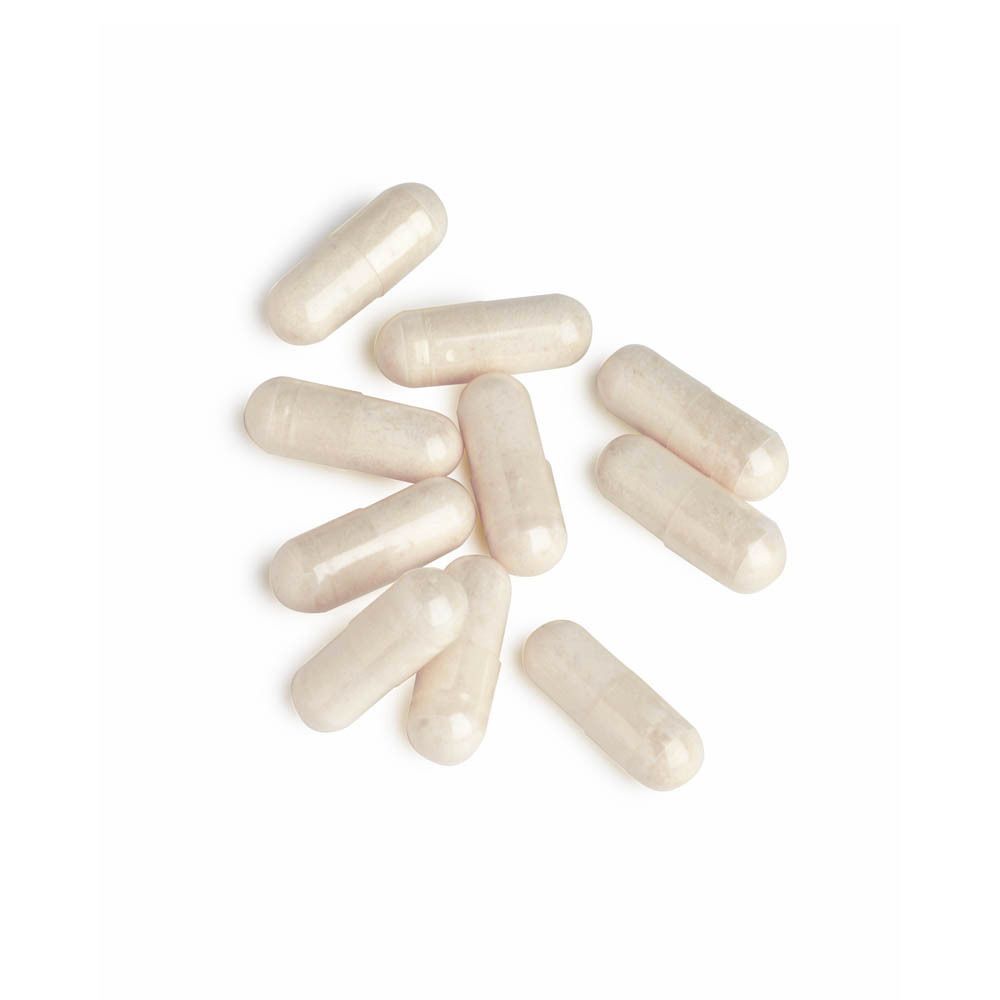 Meerdere witte capsules van ChondroSamine-S op een witte achtergrond.
