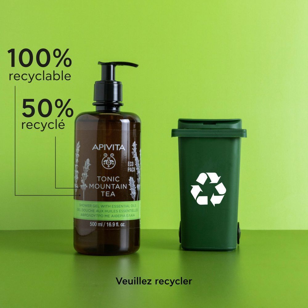 Gel douche Apivita Tonic Mountain Tea à côté d'une poubelle verte avec symbole de recyclage.
