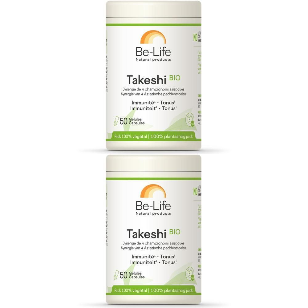 Twee witte potten met groen etiket. Opschrift: Be-Life Takeshi BIO, 50 capsules. Logo met zon en bladeren.