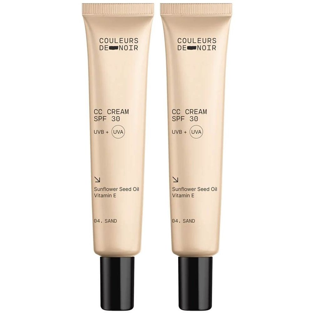 Deux tubes de crème CC. Inscription: Couleurs de Noir, CC Cream SPF 30, UVB + UVA, 04 Sand. Bouchon noir.