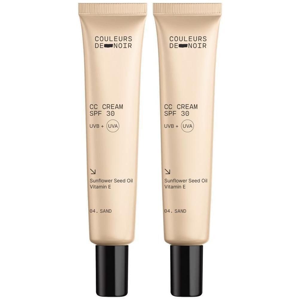 Twee tubes Couleurs de Noir CC Crème SPF30 04. Sand. Beige tubes met zwarte doppen. Tekst: CC CREAM, SPF 30, UVB + UVA.
