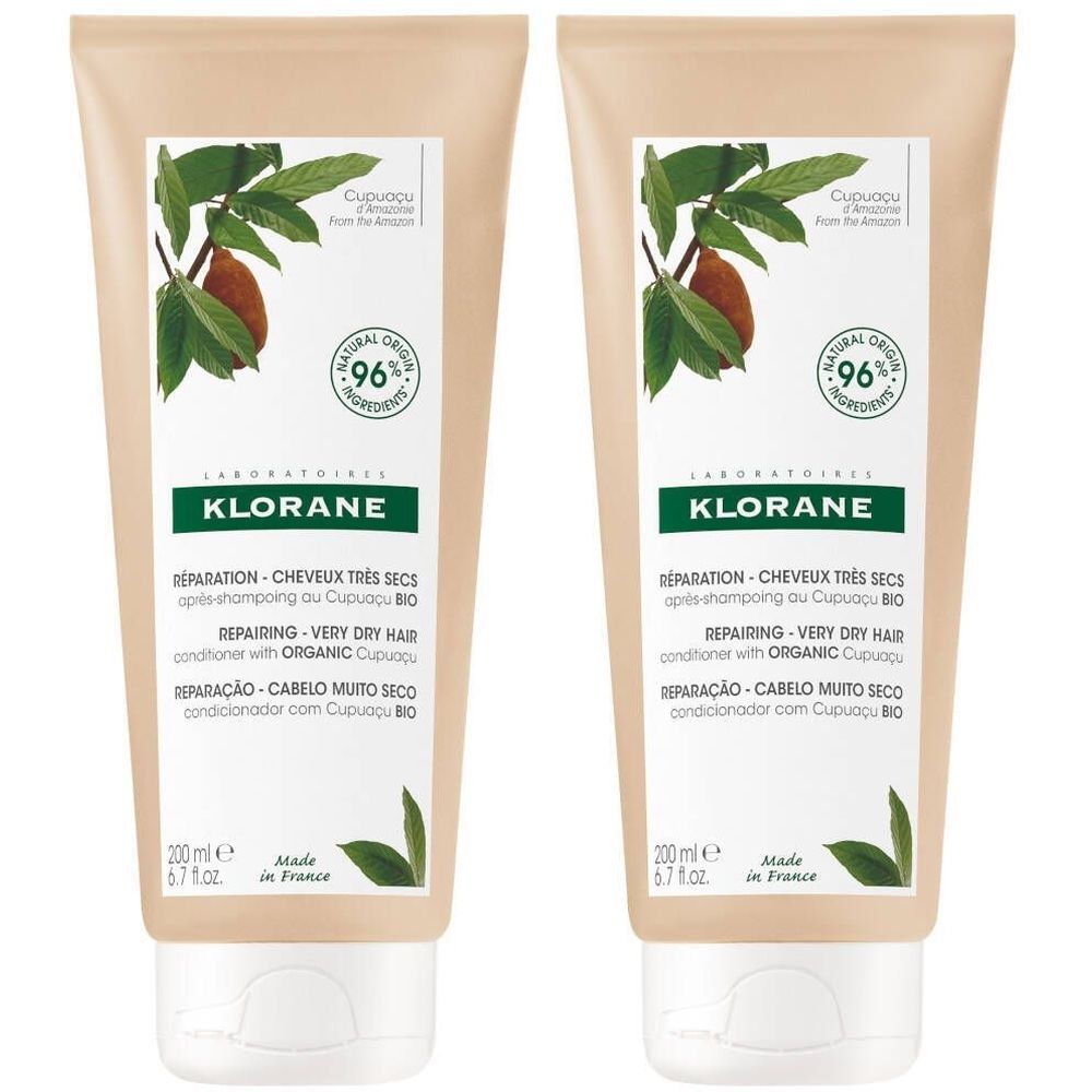 Twee tubes Klorane conditioner. Beige tubes met groene bladeren en bruine vruchten. Tekst: Réparation, 96% natuurlijke ingrediënten.