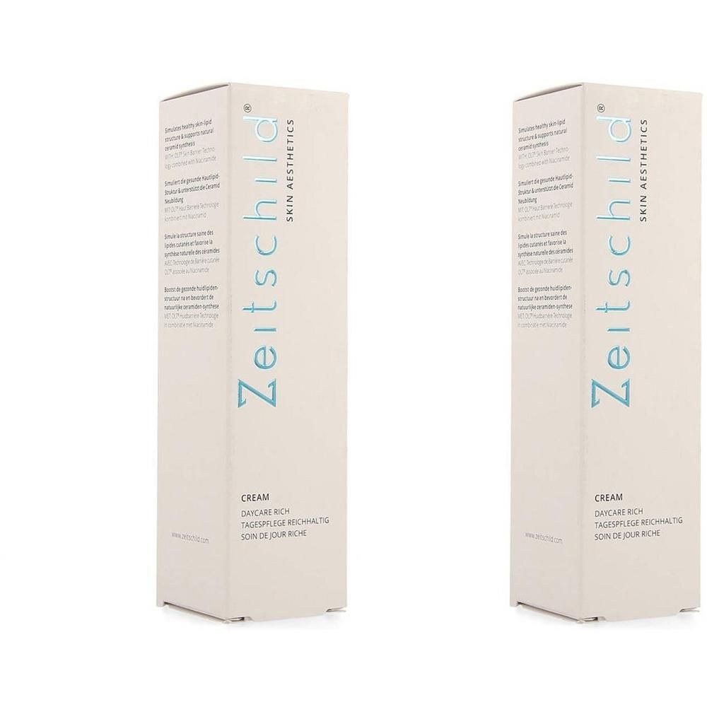 Deux boîtes rectangulaires. Inscription : Zeitschild Skin Aesthetics, Cream, Soin de Jour Riche. Texte bleu clair.