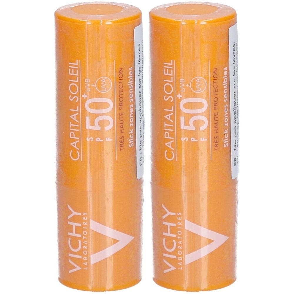 Twee oranje sticks. Opschrift: CAPITAL SOLEIL SPF 50+. VICHY LABORATOIRES. Voor gevoelige zones.