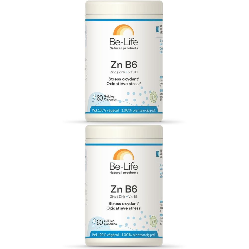 Twee witte potten met etiketten. Opschrift: Be-Life Zn B6, 60 capsules. Logo: oranje zon.