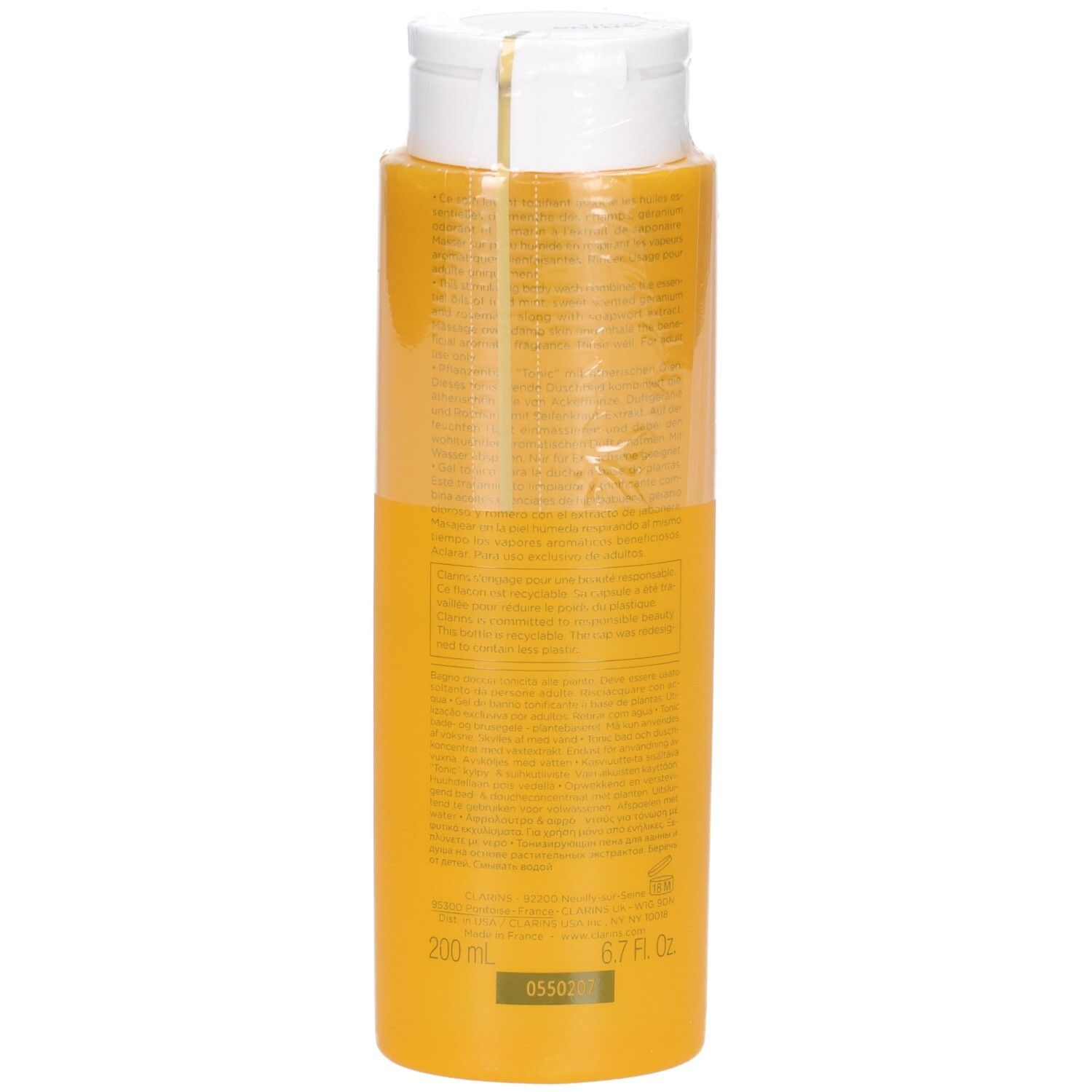 Arrière d'une bouteille jaune de Concentré Bain & Douche Tonic Clarins, indiquant 200 ml / 6.7 Fl. Oz.