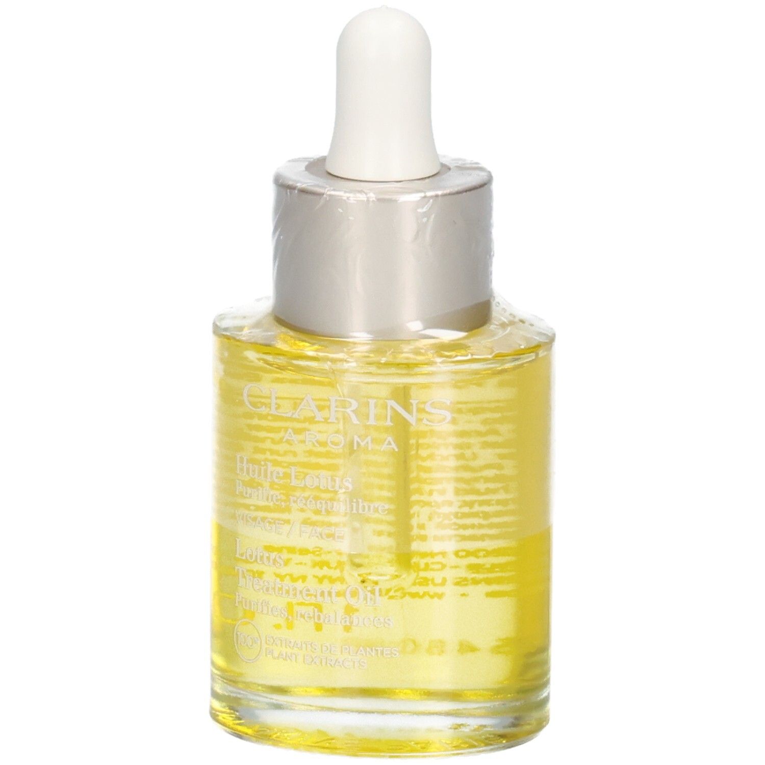 Huile Aroma Lotus Clarins. Liquide jaune dans un flacon en verre avec pipette, avec texte.