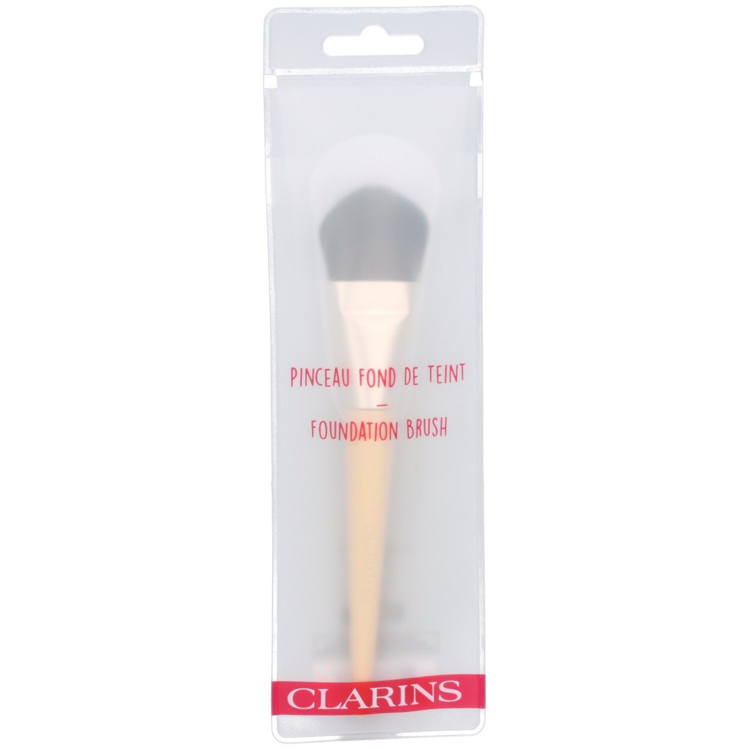 Clarins foundation kwast in doorzichtige verpakking. Lichte steel, donkere borstels.